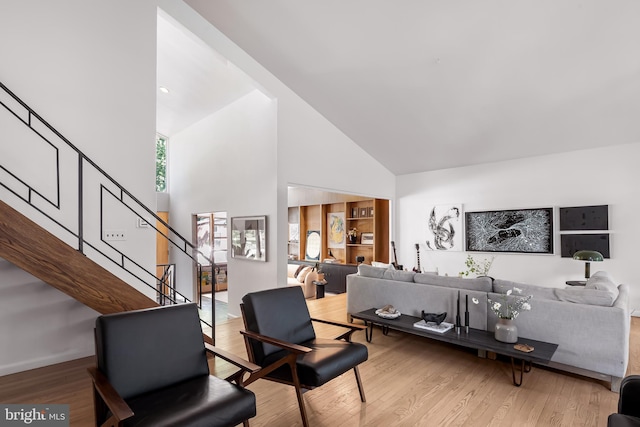 2103 Northcliff Dr, Baltimore, MD 21209 - living area featuring high vaulted ceiling, stairs, and wood finished floors