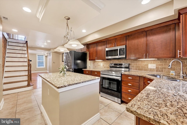 115 N Bradford St, Baltimore, MD 21224 - kitchen featuring appliances with stainless steel finishes, light tile patterned flooring, a kitchen island, backsplash, and recessed lighting