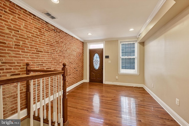 115 N Bradford St, Baltimore, MD 21224 - entrance foyer with crown molding, brick wall, wood finished floors, and recessed lighting
