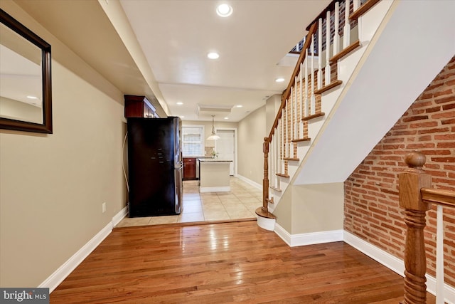 115 N Bradford St, Baltimore, MD 21224 - entryway with stairway, light wood-style floors, and recessed lighting