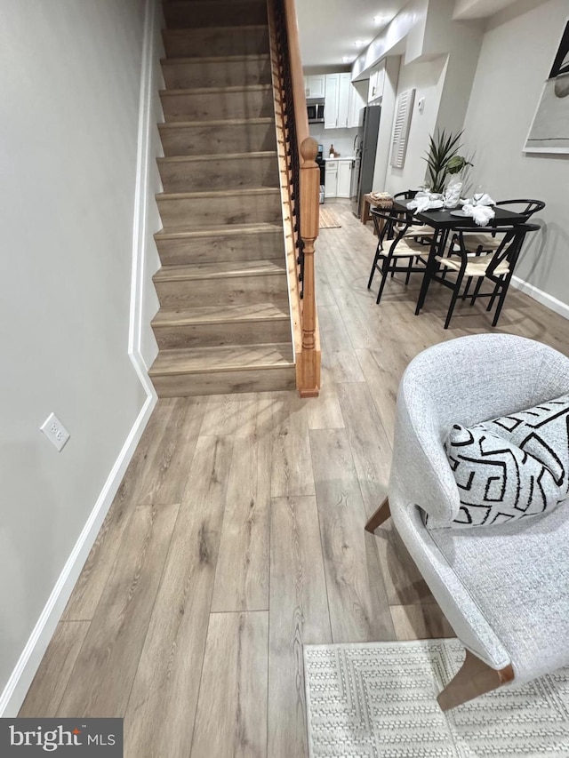 1182 Washington Blvd, Baltimore, MD 21230 - stairs featuring hardwood / wood-style floors and baseboards