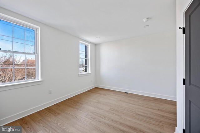 2504 E Cumberland St, Philadelphia, PA 19125 - unfurnished room featuring healthy amount of natural light, light wood-type flooring, and a smoke detector
