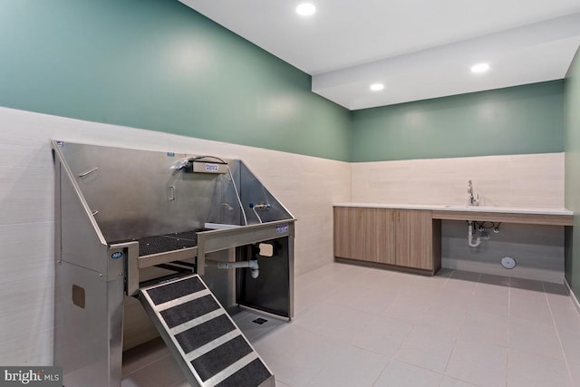 635 Slaters Ln Unit 109, Alexandria, VA 22314 - misc room with pet washing station, tile walls, a wainscoted wall, and recessed lighting