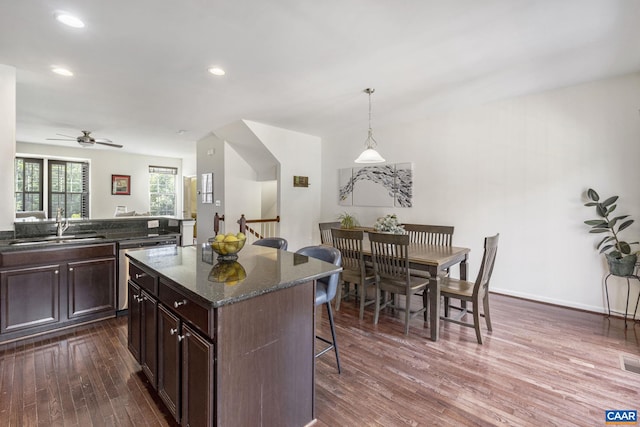2159 Whispering Hollow Ln, Charlottesville, VA 22911 - kitchen featuring a kitchen bar, dishwasher, dark wood finished floors, dark brown cabinetry, and a kitchen island