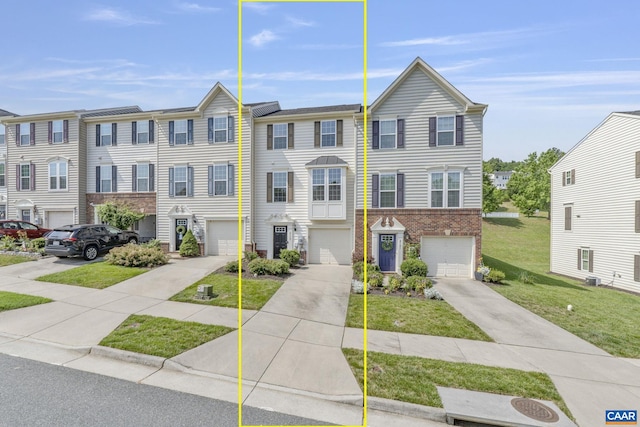 2159 Whispering Hollow Ln, Charlottesville, VA 22911 - townhome / multi-family property featuring an attached garage, driveway, brick siding, and a front yard