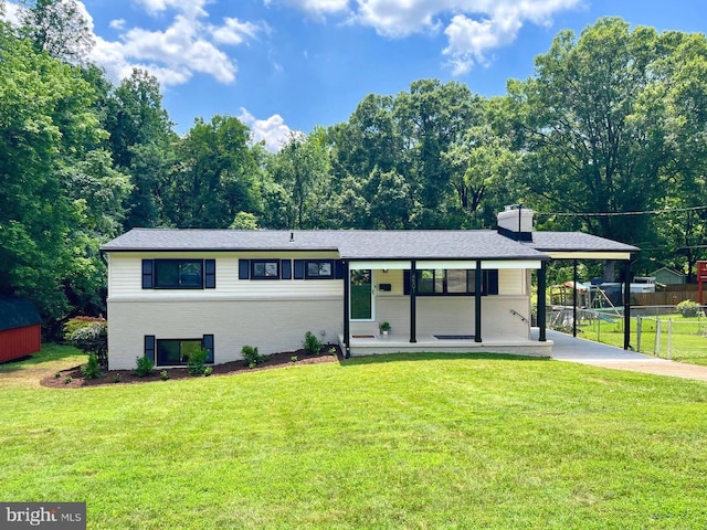 4501 Tipton Ln, Alexandria, VA 22310 - view of front of house featuring a porch, brick siding, a chimney, an attached carport, and driveway