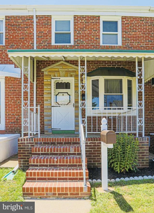 8429 Kavanagh, Baltimore, MD 21222 - view of exterior entry featuring a porch and brick siding