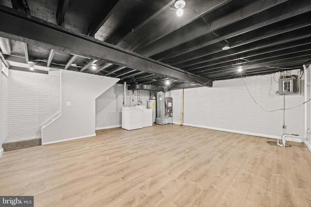 42 Brookshire Dr Unit A, Reisterstown, MD 21136 - finished basement with separate washer and dryer, wood finished floors, electric panel, water heater, and brick wall