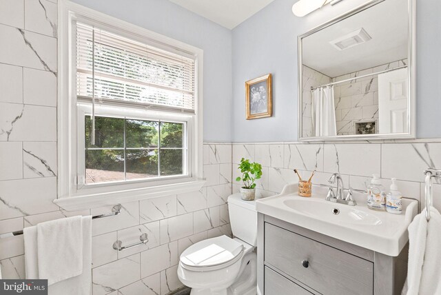 8700 Bluedale St, Alexandria, VA 22308 - bathroom with tile walls, vanity, and a shower with curtain