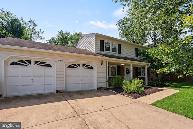 8700 Bluedale St, Alexandria, VA 22308 - traditional-style house with concrete driveway, an attached garage, and a porch