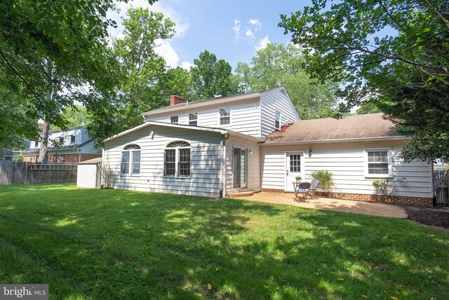 8700 Bluedale St, Alexandria, VA 22308 - back of property with a chimney, a patio area, and a storage shed