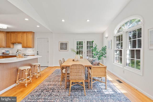 8700 Bluedale St, Alexandria, VA 22308 - dining room featuring lofted ceiling, light wood-type flooring, recessed lighting, and french doors