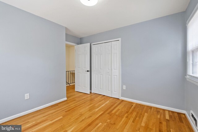 8700 Bluedale St, Alexandria, VA 22308 - unfurnished bedroom featuring light wood-type flooring and a closet