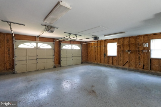 8700 Bluedale St, Alexandria, VA 22308 - garage featuring a garage door opener and wood walls