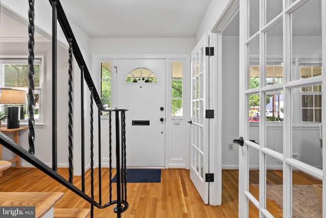 8700 Bluedale St, Alexandria, VA 22308 - foyer with light wood-type flooring, french doors, and stairway