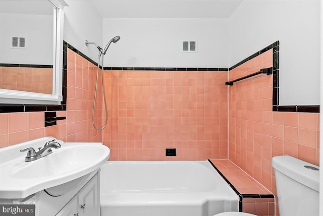 307 19th St NE, Washington, DC 20002 - bathroom featuring tile walls, tub / shower combination, and vanity