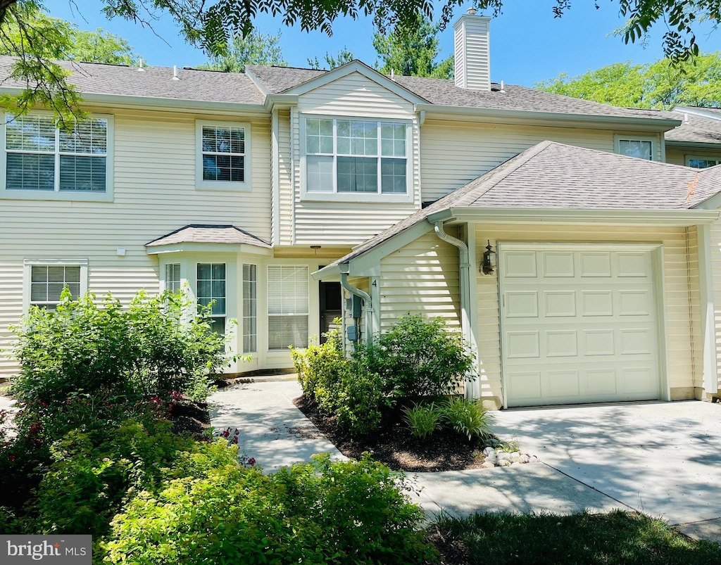 4 Dorset Ct, Princeton, NJ 08540 - view of property with a garage, a chimney, and concrete driveway
