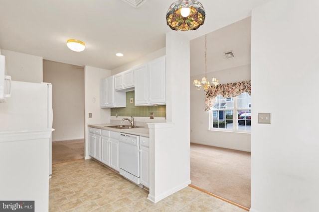 26 Courtyard Dr, Carlisle, PA 17013 - kitchen featuring white appliances, a chandelier, light colored carpet, light countertops, and decorative backsplash
