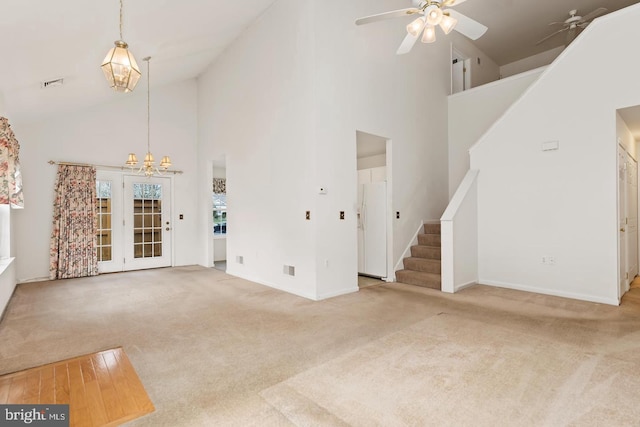 26 Courtyard Dr, Carlisle, PA 17013 - unfurnished living room with high vaulted ceiling, carpet flooring, stairway, ceiling fan, and a chandelier