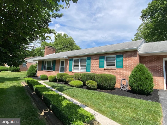 13343 Keener Rd, Hagerstown, MD 21742 - ranch-style house featuring brick siding, a front yard, a chimney, and roof with shingles
