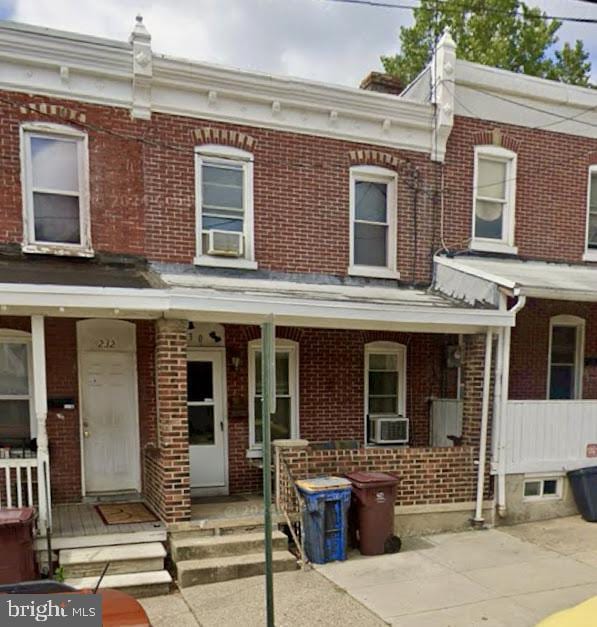 230 6th Ave, Wilmington, DE 19805 - view of property with brick siding, covered porch, and cooling unit