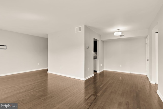 6930 Hanover Pkwy Unit 302, Greenbelt, MD 20770 - empty room with dark wood-style floors and baseboards