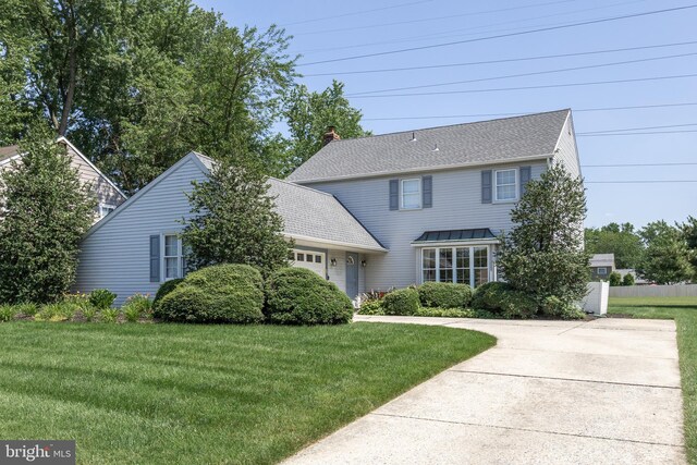 325 Tenby Chase Dr, Delran, NJ 08075 - view of front of property with an attached garage, a front lawn, a chimney, and driveway
