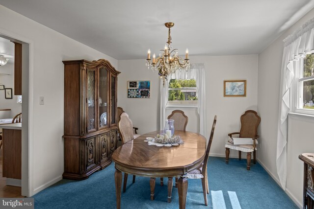325 Tenby Chase Dr, Delran, NJ 08075 - carpeted dining area with a chandelier and baseboards