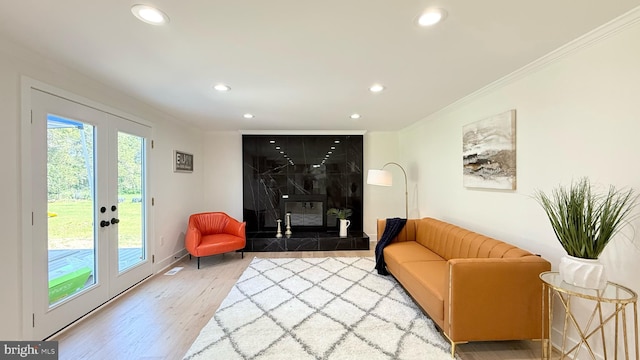 904 Man O War Ln, Great Falls, VA 22066 - living area featuring recessed lighting, wood finished floors, ornamental molding, a tiled fireplace, and french doors