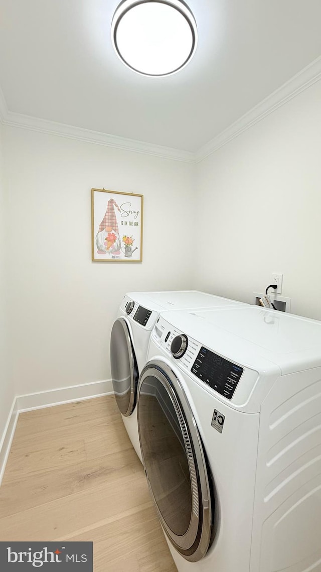 904 Man O War Ln, Great Falls, VA 22066 - washroom featuring independent washer and dryer, crown molding, and light wood-type flooring