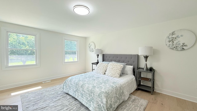 904 Man O War Ln, Great Falls, VA 22066 - bedroom featuring multiple windows and light wood-type flooring