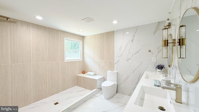 904 Man O War Ln, Great Falls, VA 22066 - full bathroom with tile walls, double vanity, a marble finish shower, and recessed lighting