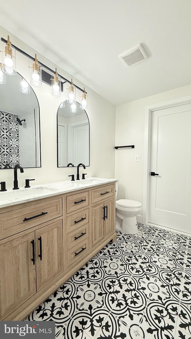 904 Man O War Ln, Great Falls, VA 22066 - bathroom with double vanity and tile patterned flooring
