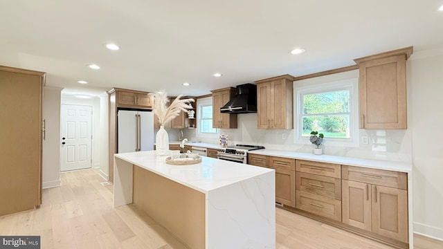 904 Man O War Ln, Great Falls, VA 22066 - kitchen featuring wall chimney exhaust hood, stainless steel appliances, light wood-style floors, recessed lighting, and a kitchen island with sink