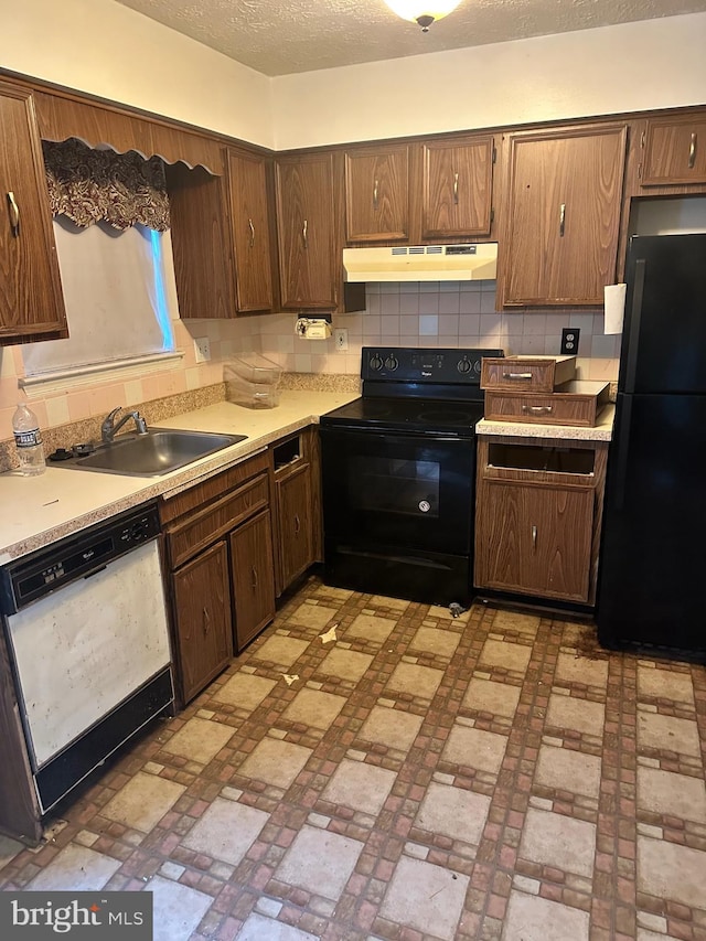 2407 E Rosecroft Village Cir, Oxon Hill, MD 20745 - kitchen featuring black appliances, under cabinet range hood, light countertops, and brick patterned flooring