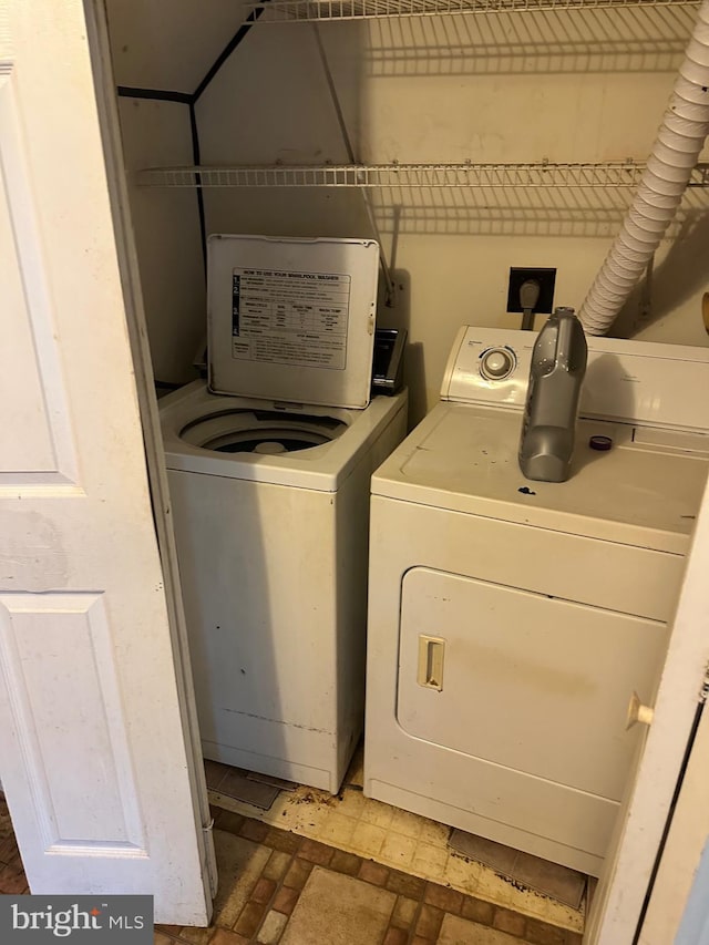 2407 E Rosecroft Village Cir, Oxon Hill, MD 20745 - laundry room with separate washer and dryer and brick patterned flooring