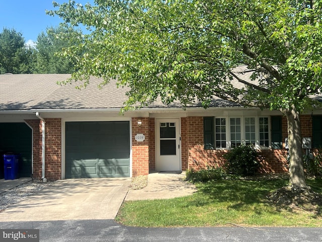 1038 Matthew Ct, Hagerstown, MD 21742 - view of front of house featuring an attached garage, driveway, brick siding, and a shingled roof