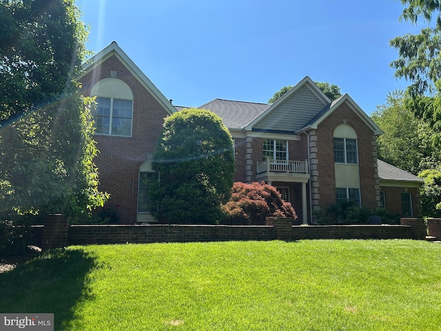 10505 Dunn Meadow Rd, Vienna, VA 22182 - georgian-style home featuring brick siding and a front lawn