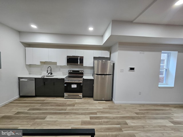 3239 N 13th St, Philadelphia, PA 19140 - kitchen featuring appliances with stainless steel finishes, white cabinetry, light countertops, light wood finished floors, and recessed lighting