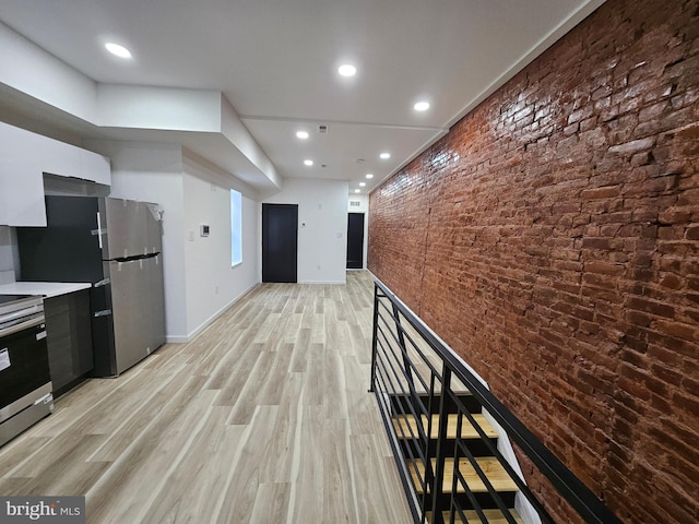3239 N 13th St, Philadelphia, PA 19140 - hallway with light wood-type flooring, brick wall, and recessed lighting
