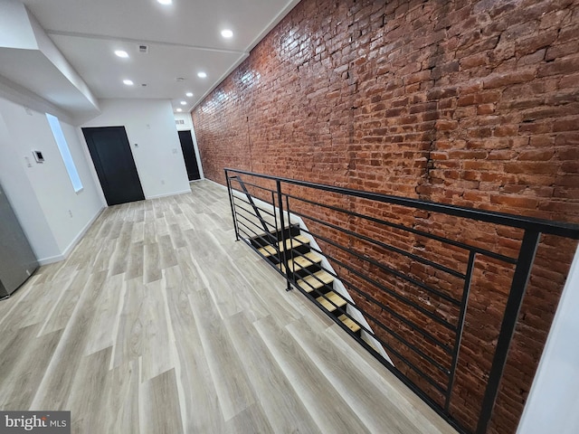 3239 N 13th St, Philadelphia, PA 19140 - hall with brick wall, recessed lighting, light wood-type flooring, and an upstairs landing