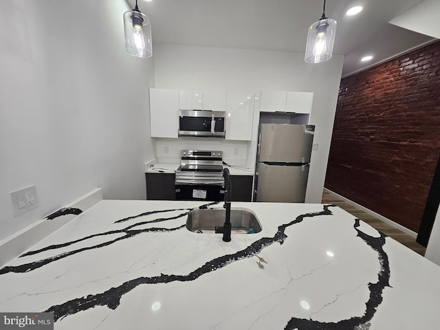 3239 N 13th St, Philadelphia, PA 19140 - kitchen featuring appliances with stainless steel finishes, white cabinetry, wood finished floors, pendant lighting, and recessed lighting
