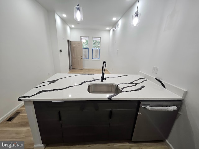 3239 N 13th St, Philadelphia, PA 19140 - kitchen featuring dark cabinetry, light countertops, light wood finished floors, decorative light fixtures, and recessed lighting