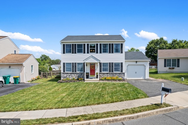 1015 Jodie Ct, Pennsburg, PA 18073 - colonial house featuring an attached garage, asphalt driveway, and stone siding