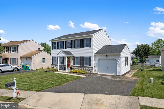 1015 Jodie Ct, Pennsburg, PA 18073 - view of front of property featuring a garage, stone siding, asphalt driveway, and a shingled roof