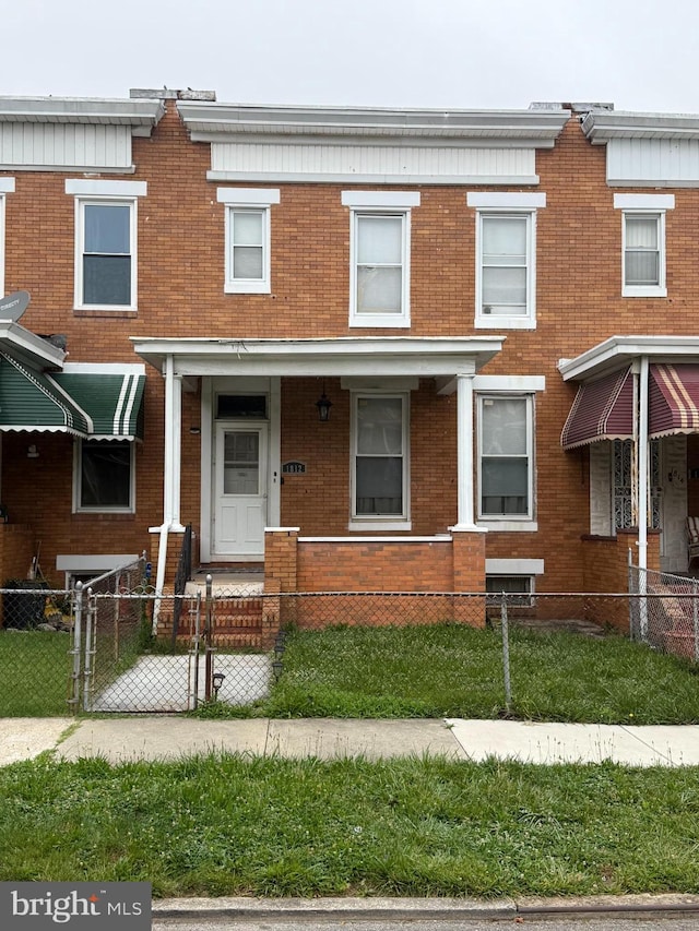 1812 E 32nd St, Baltimore, MD 21218 - multi unit property featuring brick siding, a fenced front yard, and a gate