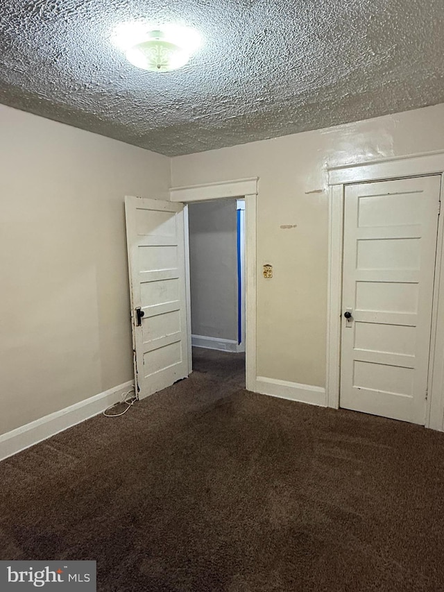 1812 E 32nd St, Baltimore, MD 21218 - carpeted spare room featuring a textured ceiling and baseboards