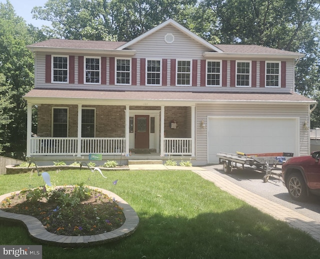 1165 Neptune Pl, Annapolis, MD 21409 - view of front of property featuring an attached garage, a porch, driveway, and a front lawn