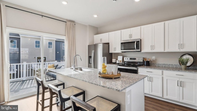 178 Munsee Cir, Winchester, VA 22602 - kitchen with appliances with stainless steel finishes, dark wood-style floors, a kitchen island with sink, white cabinetry, and recessed lighting