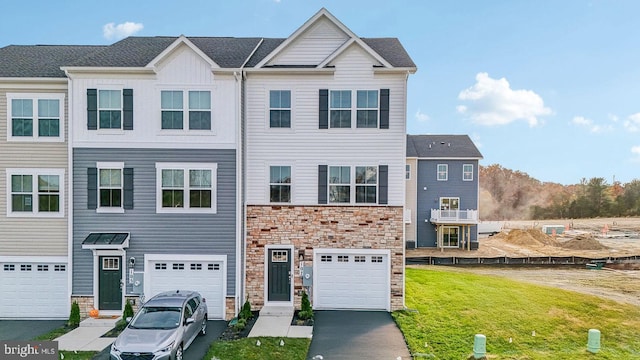 178 Munsee Cir, Winchester, VA 22602 - townhome / multi-family property featuring stone siding, driveway, a garage, and a front lawn
